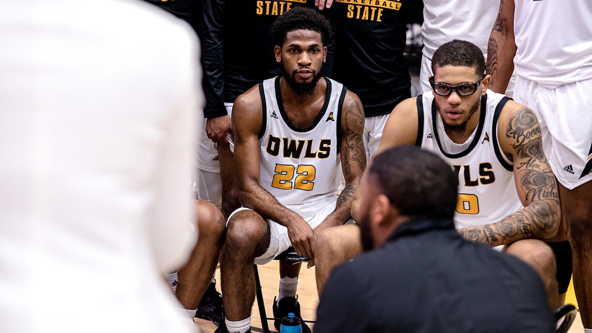 Players are listening to what their coach is saying. 